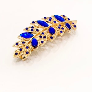 Gold leaf hair clip with blue rhinestone stones and decorative barrette prongs