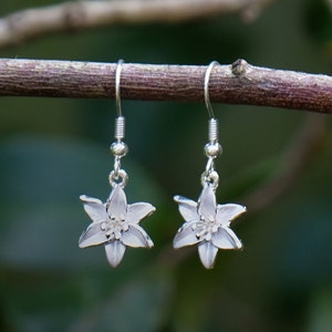 Silver flower drop hook earrings with small dangling blossoms