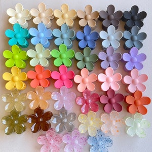 Assorted colorful flower-shaped hair claw clips with pastel and bright tones