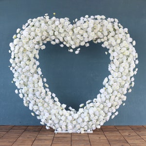 Heart-shaped white flower arch made of small blossoms for wedding backdrop