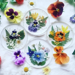 Set of round resin flower coasters with pressed pansy and mixed wildflowers