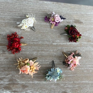 Assorted floral snap hair clips set with pink, red, purple, and blue flowers
