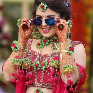 Artificial floral jewelry set with red green statement necklace and matching earrings