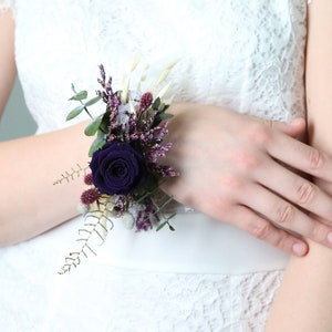 Dark purple preserved flower wrist corsage with dried blooms and ribbon ties