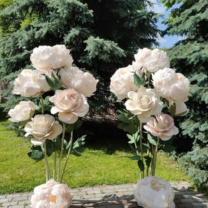 Set of large white paper peony and rose-style flowers with green stems