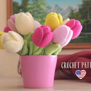 Crochet tulip amigurumi bouquet in pink pot: cream, yellow, and pink flowers with green leaves