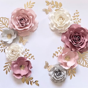Nursery paper flower wall decor set with pink, cream, and gray rosette flowers, gold accents
