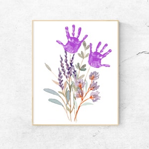 Framed flower handprint craft print with two purple handprints and floral stems
