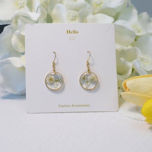 Gypsophila flower resin dangle earrings with gold-tone hooks, white blooms in round drops