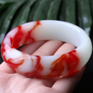 White jade bangle with red flower pattern, glossy round bracelet