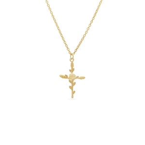 Gold cross necklace with small floral flower details on a hanging pendant