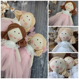 Three mini flower girl dolls with pink tulle skirts and beige hair, face details