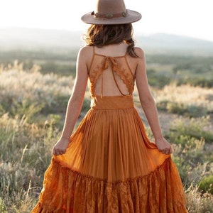 Orange boho flower girl dress with lace trim spaghetti straps and tiered skirt