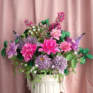 Paper flower bouquet with pink and purple blooms in a white vase