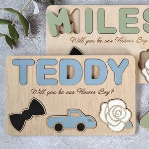 Wooden puzzle sign with Teddy name, flower boy question, car and rose icons