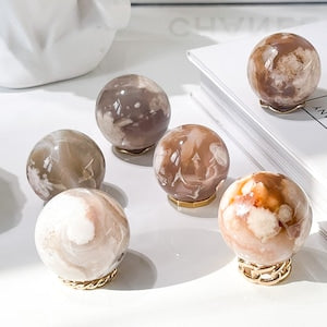 Cream and brown flower agate crystal sphere with white veining, gold-tone base