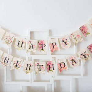 Happy birthday floral banner with pink and white bunting letters