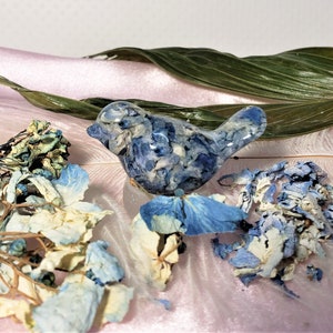 Blue dried-flower bird ornament with layered petals and nest accents