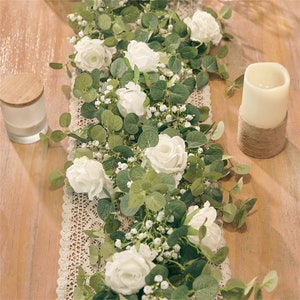 Artificial eucalyptus floral garland with green leaves, white roses, and small white blooms