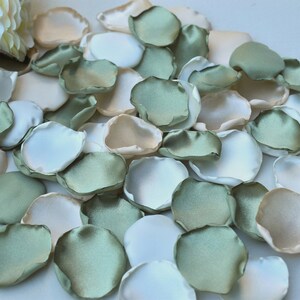 Sage green and ivory rose petals, scattered for wedding decorations