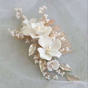 White floral pearl hair comb with cream blossoms, pearl beads, and leaf accents