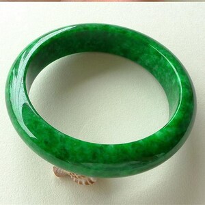 Dark green jadeite jade bangle with smooth polished oval shape