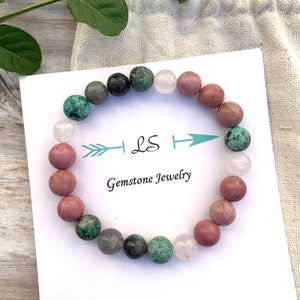 Multicolor gemstone stretch bracelet with pink, green, and gray round beads