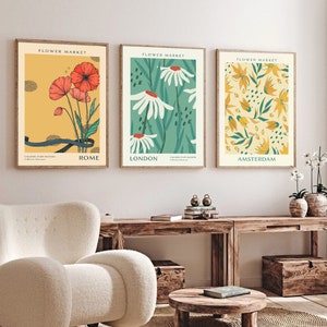 Botanical wall art set of 3 prints with floral, leaf, and insect illustrations, framed