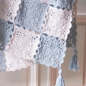 Crochet flower-square blanket in light blue and white with hanging tassels