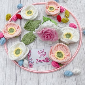 Felt flower baby mobile with pink yellow and blue blooms in a ring