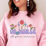 Pink sweatshirt with 'OB NURSE' and 'at your cervix' floral front print