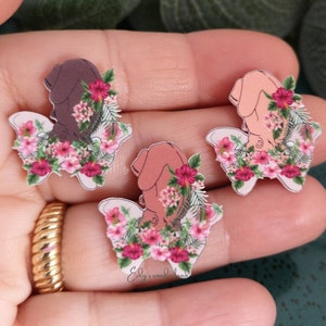 Enamel lapel pin with pink floral baby-in-womb pelvis design