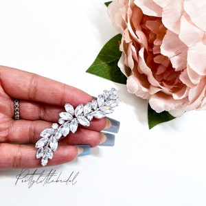 Silver rhinestone hair clip with floral cluster design, sparkling crystal stones.