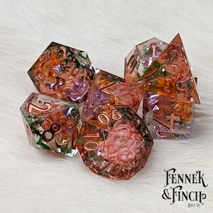 Polyhedral D&D dice set in clear resin with dried flowers and moss accents