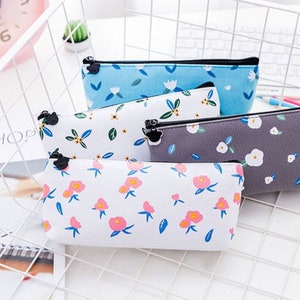 Multicolor floral zip pencil case pouch, top zipper and rounded corners.