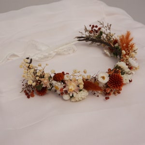 Dried flower hair wreath crown with orange and cream blooms and small brown accents