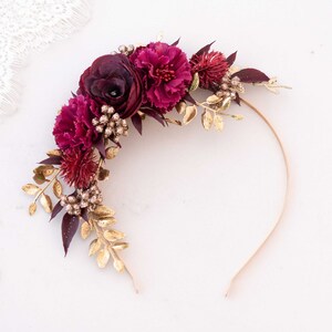 Floral hair headband with dark red and purple roses, gold leaves, and pearl accents