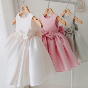 Puffy satin baby girls dress with bow, sleeveless layered skirt, white and pink