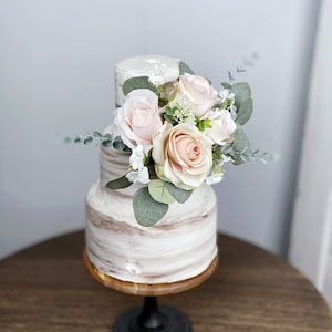 Floral cake topper with dusty pink and cream roses, blush blooms, and green leaves