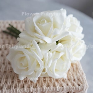 White artificial rose bouquet with five latex-like stems, close-up