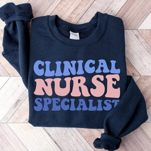 Dark navy sweatshirt with bold "CLINICAL NURSE SPECIALIST" front print