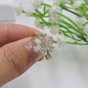 Gold-tone flower-shaped diamond anniversary ring with five sparkling pear-cut stones