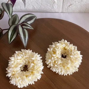 White floral gajra hair accessory with two round chrysanthemum-style flowers