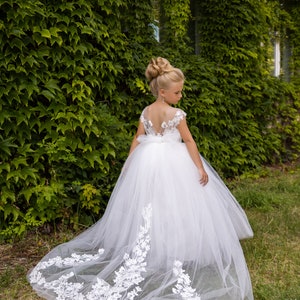 Ivory tulle flower girl dress with lace bodice, floral appliques, and long train