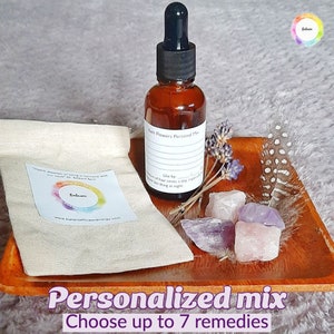 Bach flower remedies dropper bottle with amber liquid, paper pouch, and crystal stones