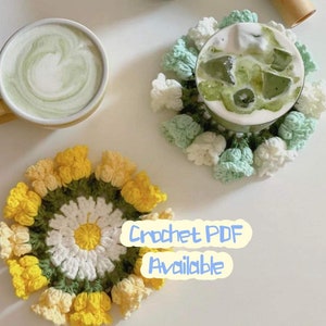 Round crochet flower coaster with yellow petals and white center