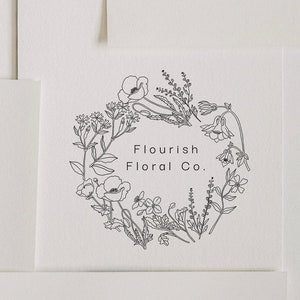 Floral wreath stamp logo with outlined flowers and “Flourish Floral Co” text