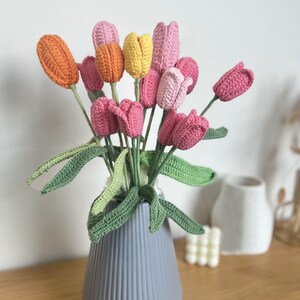 Handmade crochet tulip flowers bouquet with pink, yellow, orange blooms in vase