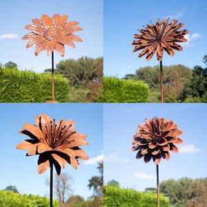 Handmade metal flower plant stake with layered copper-peach petals on a slender yard stake