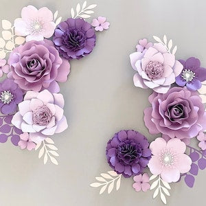 Lilac and pink paper flower wall decor set with layered blooms and leaf accents